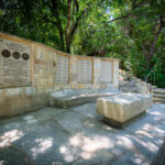 Memorial wall and stone seating area at Remembrance Gardens in Austin, Texas