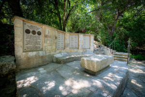 Memorial wall and stone seating area at Remembrance Gardens in Austin, Texas